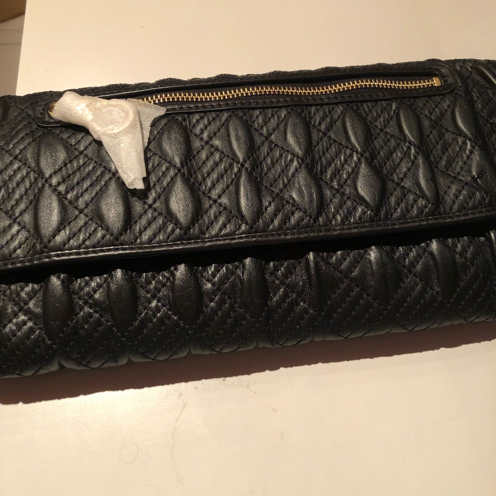 NWT Gorgeous Cole Haan black leather clutch with beautiful leather detailing.